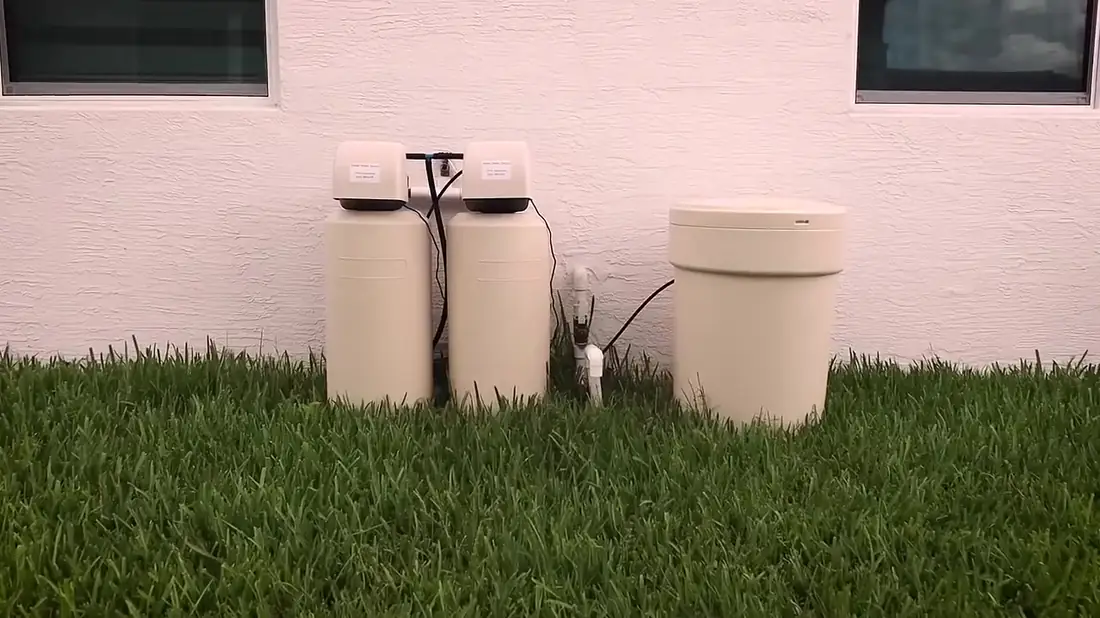 Simple Water Service softener and brine tank installed outside a Palm Beach County home
