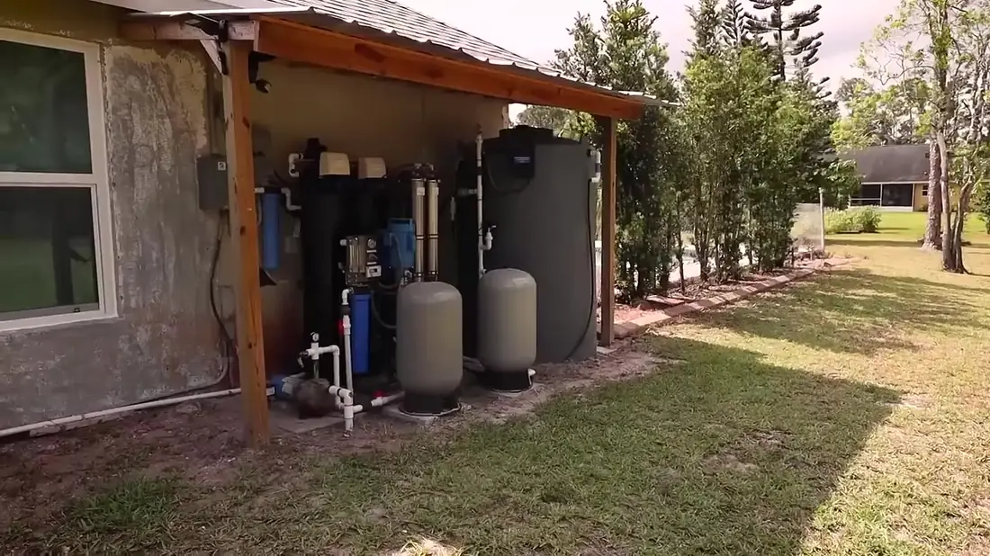 Whole-house reverse osmosis and storage system under a covered lean-to