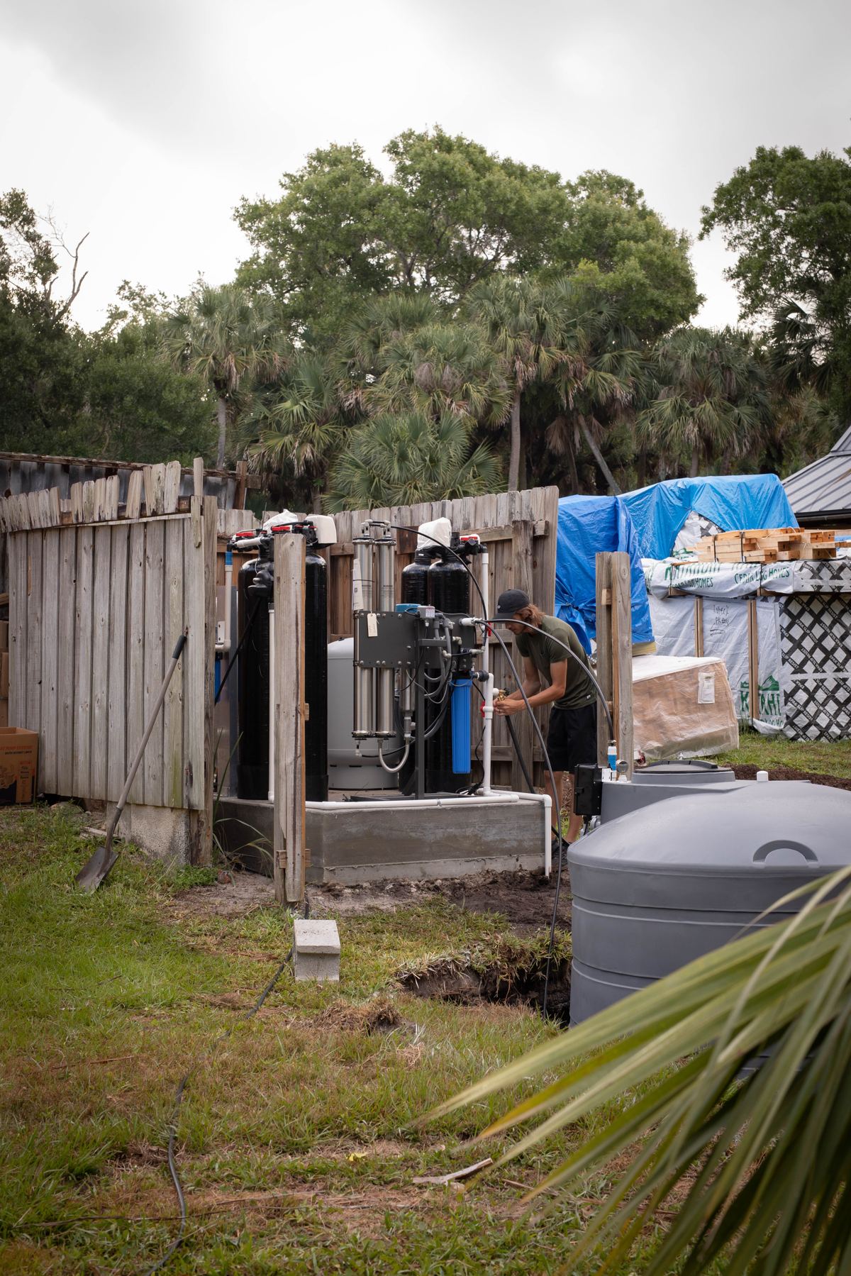 Simple Water Service technician installing a whole-home water softener and filtration system in West Palm Beach